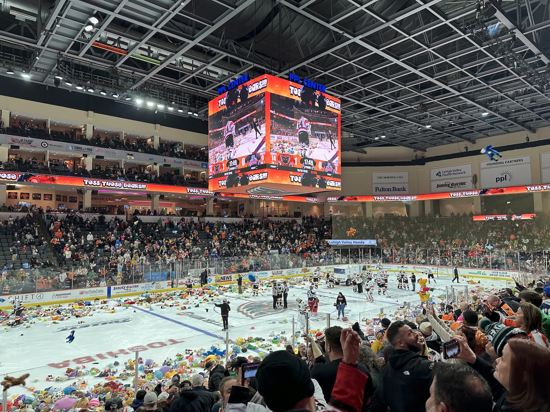 Teddy bears litter the ice at a hockey game