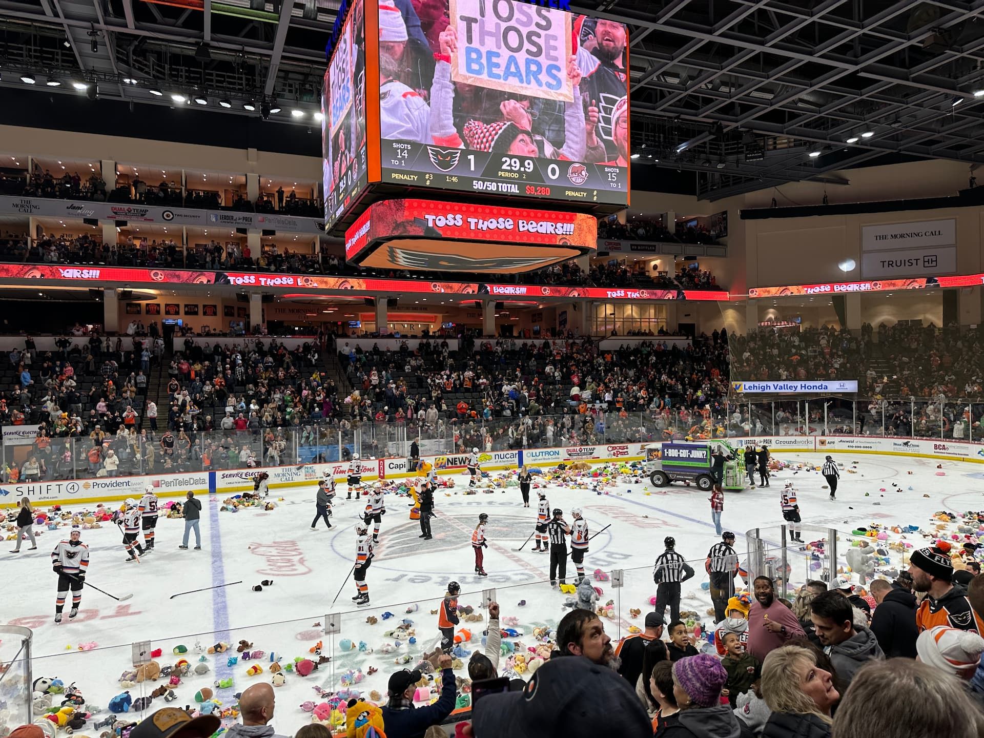 Teddy bears litter the ice at a hockey game