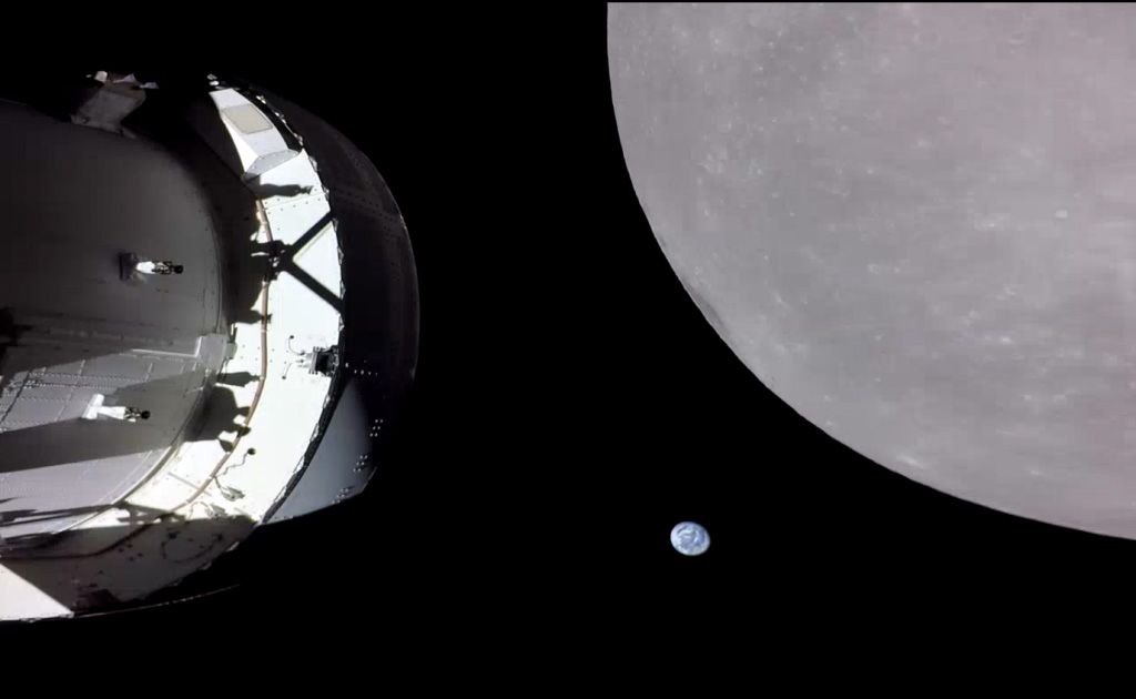 NASA's Orion capsule floating in space with Earth rising up above the Moon