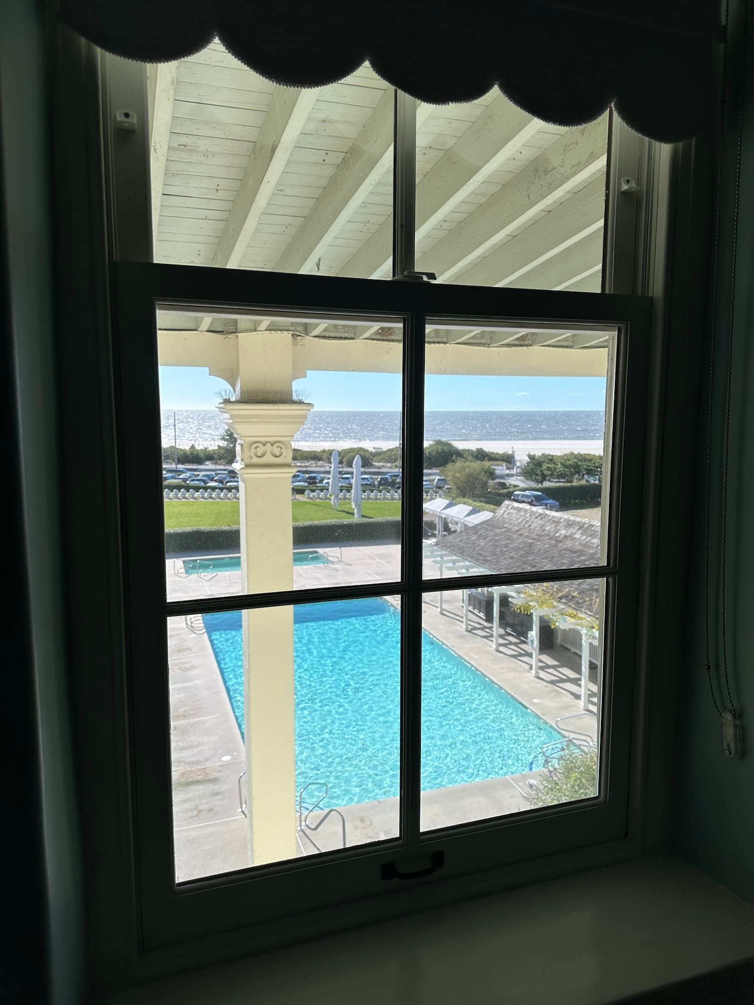 View from my hotel window, a pool and the ocean in the distance