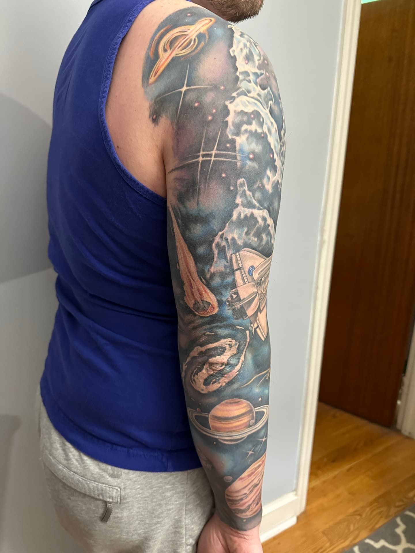 The back of my sleeve featuring saturn, jupiter, a galaxy, a meteor, and a black hole
