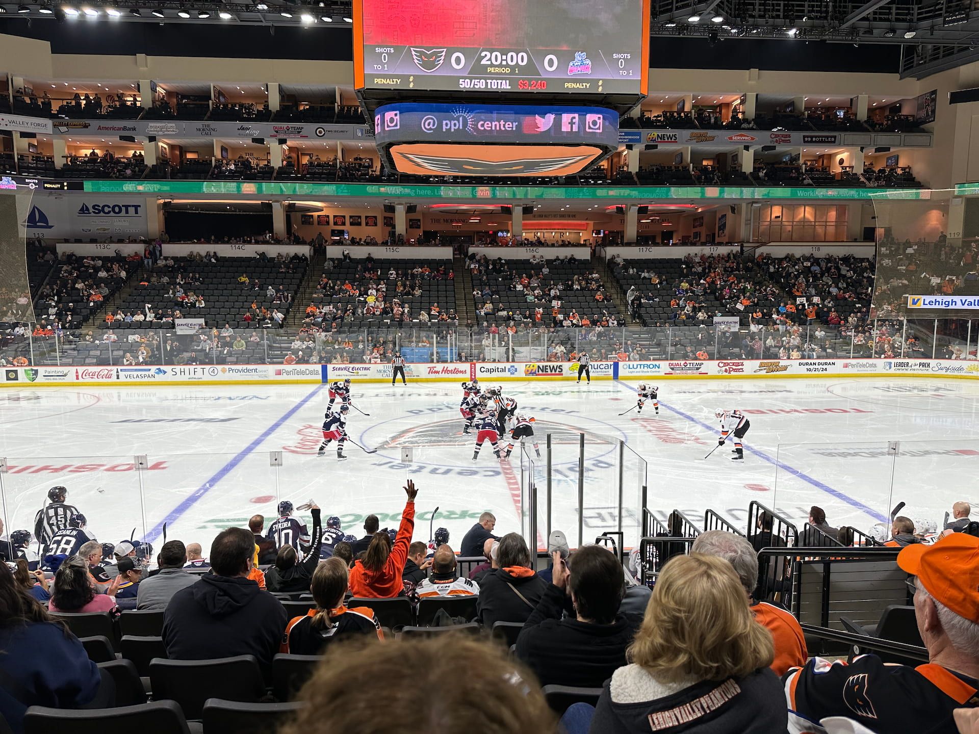 The Lehigh Valley Phantoms and the Hartford Wolf Pack at the opening faceoff at center ice at a hockey rink