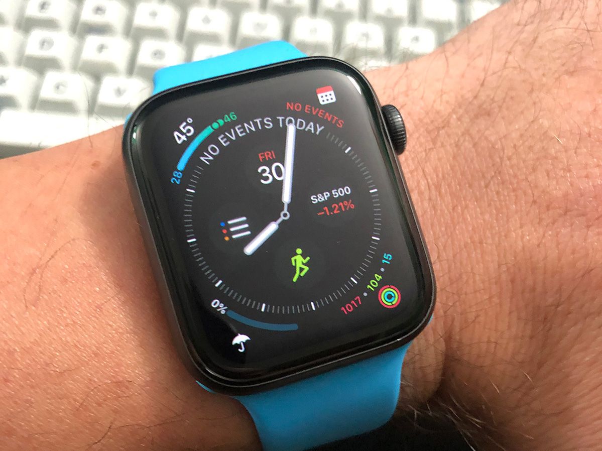 My apple watch with a blue wristband on my wrist
